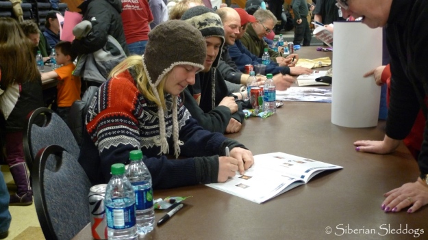 Yvonne, Joar & all the other mushers sign autographs in Nome